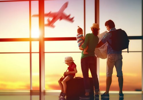 Happy family with suitcases in the airport.